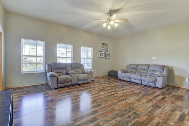 living room featuring ceiling fan and dark hardwood / wood-style floors