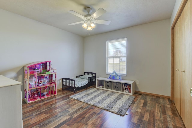 bedroom with ceiling fan, a closet, and dark hardwood / wood-style floors