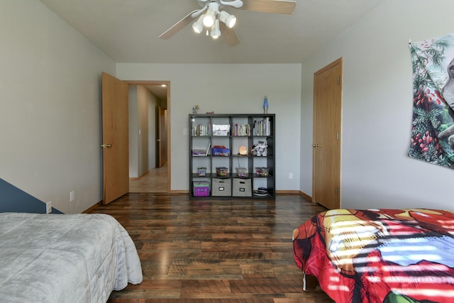 bedroom with ceiling fan and dark hardwood / wood-style floors