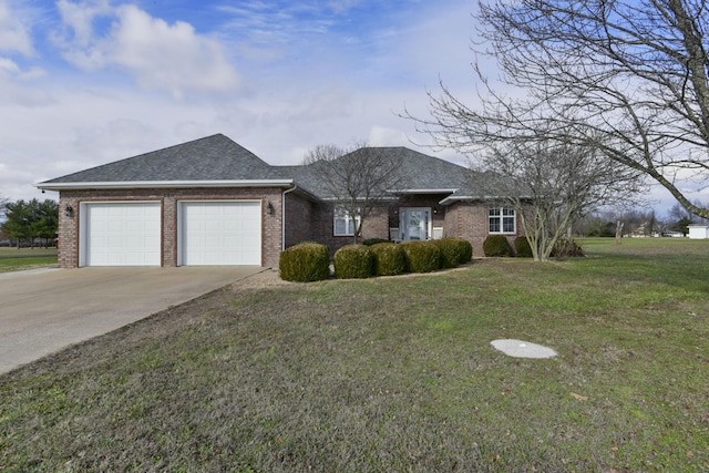 ranch-style house featuring a front yard and a garage