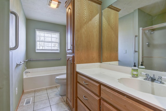 full bathroom featuring toilet, vanity, tile patterned flooring, plus walk in shower, and a textured ceiling