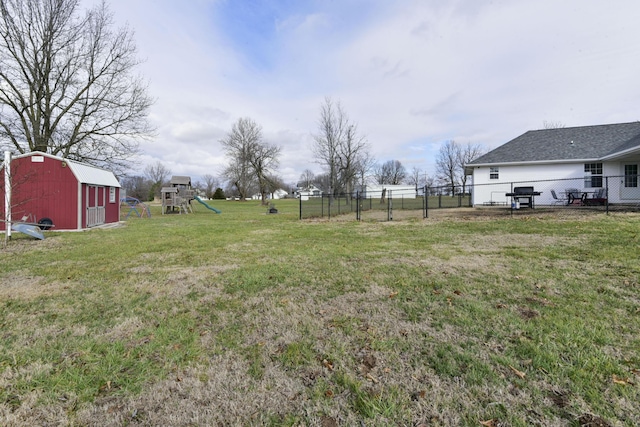 view of yard with a playground and an outbuilding