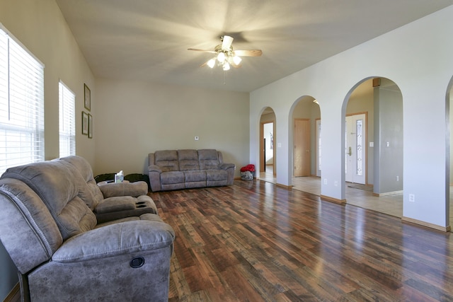 living room with ceiling fan and dark hardwood / wood-style floors