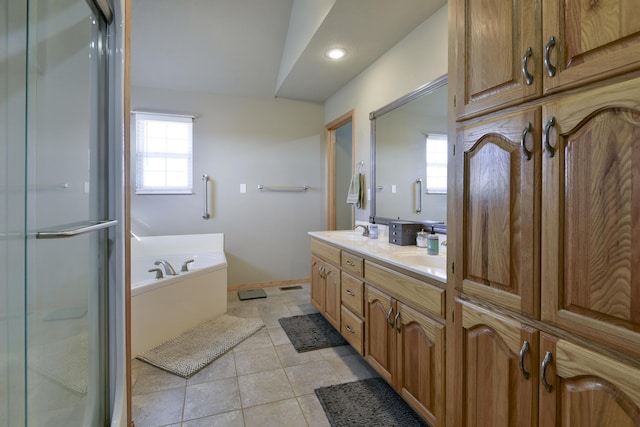 bathroom with plenty of natural light, tile patterned floors, vanity, and plus walk in shower