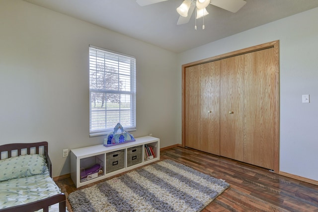 bedroom featuring a closet, dark hardwood / wood-style flooring, and ceiling fan