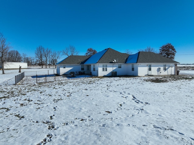 view of snow covered back of property