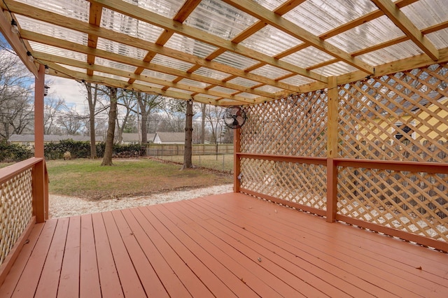 wooden terrace with a lawn and a pergola