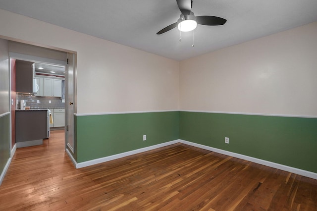 unfurnished room featuring hardwood / wood-style floors and ceiling fan