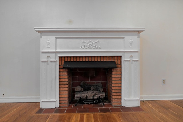 room details with hardwood / wood-style flooring and a fireplace