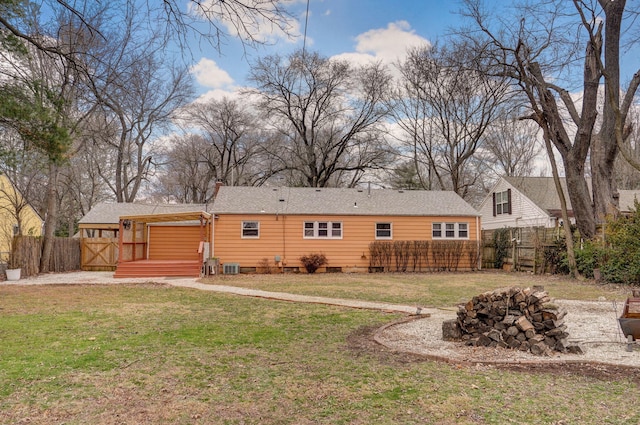 rear view of property featuring a yard