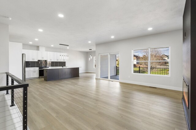 unfurnished living room featuring light hardwood / wood-style floors