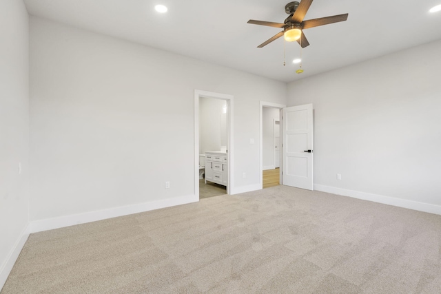 unfurnished bedroom featuring connected bathroom, ceiling fan, and light carpet