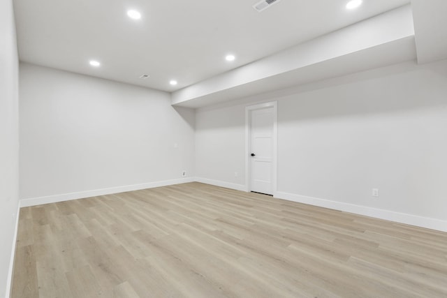 basement with light hardwood / wood-style flooring