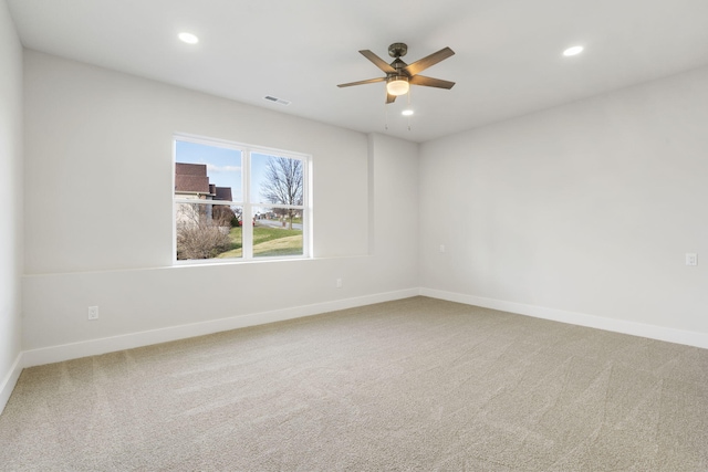 carpeted empty room featuring ceiling fan