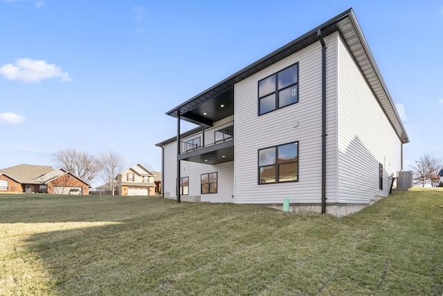 back of property featuring a yard, a balcony, and cooling unit