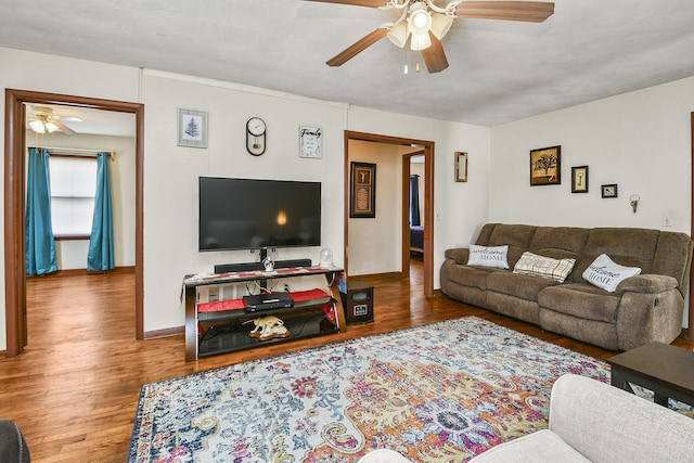 living room featuring a textured ceiling, hardwood / wood-style flooring, and ceiling fan