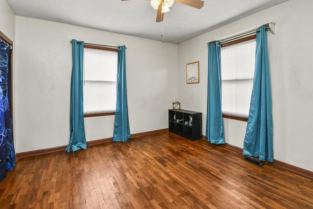 spare room featuring dark hardwood / wood-style floors and ceiling fan