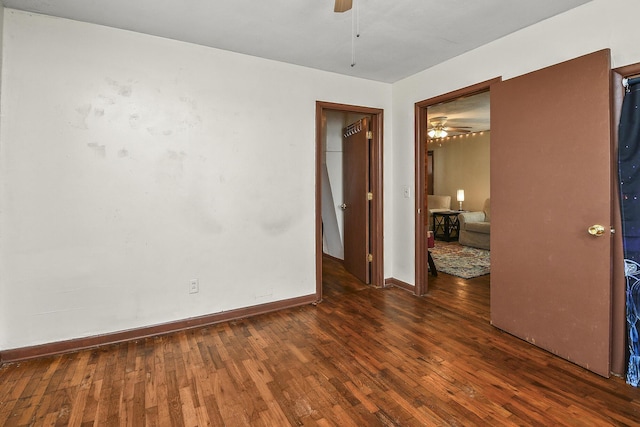 unfurnished room with dark hardwood / wood-style flooring and ceiling fan