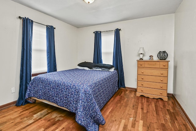 bedroom with dark hardwood / wood-style floors