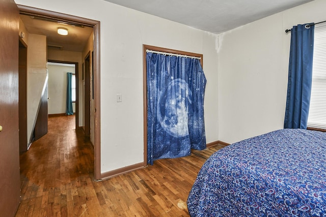 bedroom with hardwood / wood-style flooring and a closet