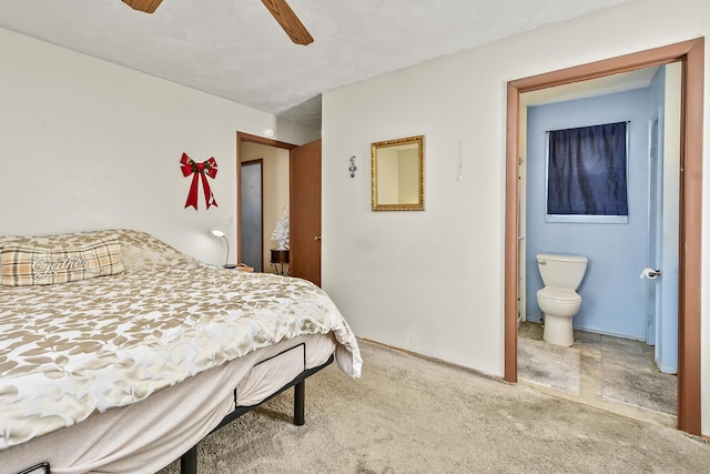 bedroom with carpet flooring, ensuite bath, and ceiling fan