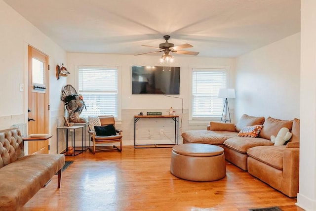 living room featuring ceiling fan and light hardwood / wood-style flooring