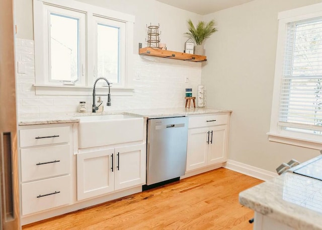 kitchen with decorative backsplash, dishwasher, white cabinets, and sink