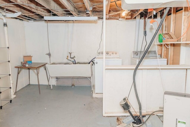 basement featuring independent washer and dryer and sink