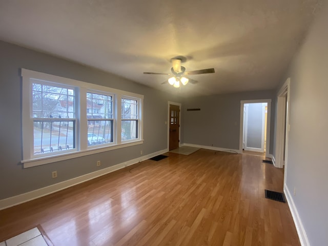 unfurnished living room featuring light hardwood / wood-style floors and ceiling fan