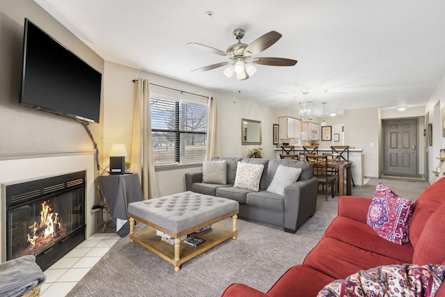 living room with ceiling fan with notable chandelier and light tile patterned flooring