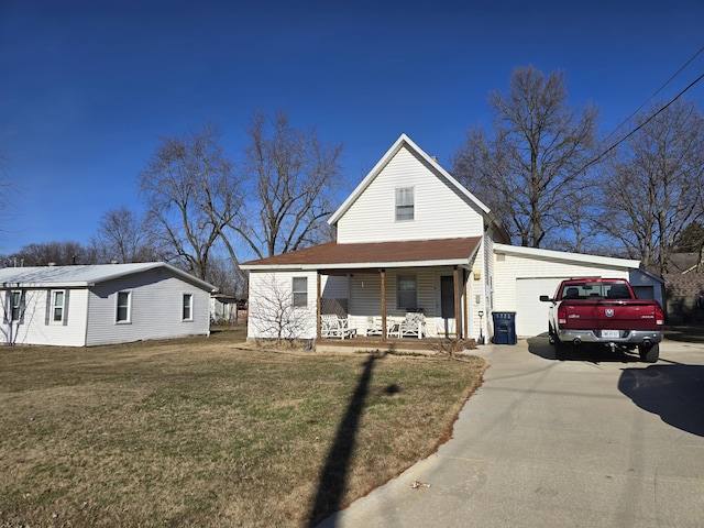 view of front facade featuring a front lawn, covered porch, and a garage