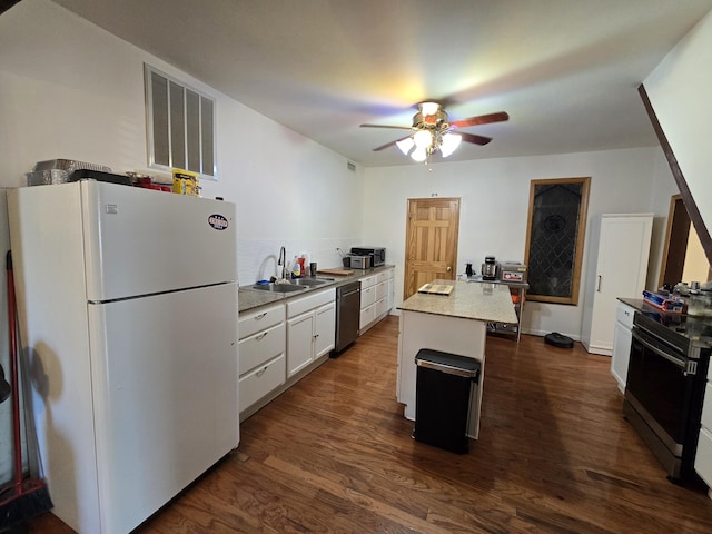 kitchen with a center island, white cabinets, white refrigerator, sink, and stainless steel dishwasher