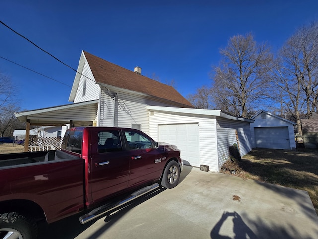 view of side of home with an outbuilding and a garage