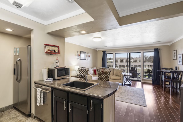 kitchen with dark hardwood / wood-style flooring, sink, ornamental molding, and appliances with stainless steel finishes