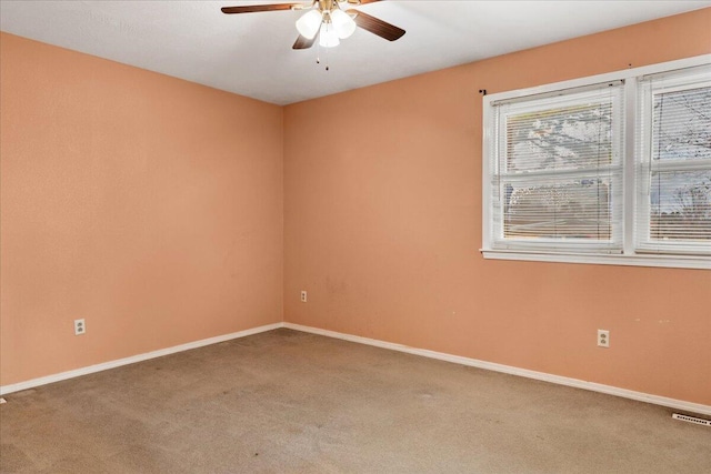 spare room featuring carpet flooring and ceiling fan