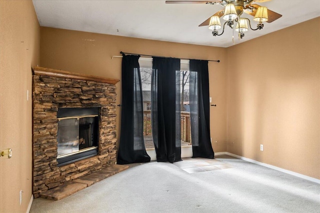 unfurnished living room with a fireplace, light colored carpet, and ceiling fan