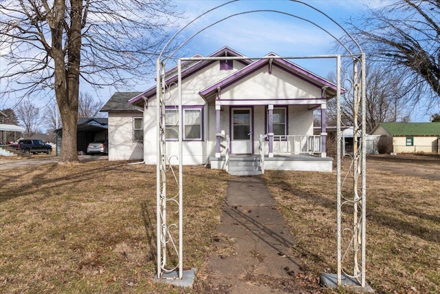 view of front of property with a porch and a front yard