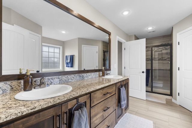 bathroom with vanity and an enclosed shower