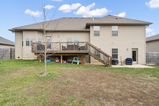 back of house with a lawn, a patio, and a wooden deck