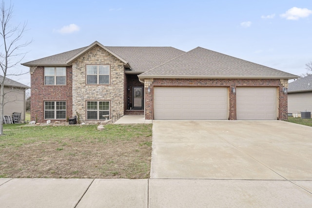 view of front facade with a front lawn, a garage, and central AC