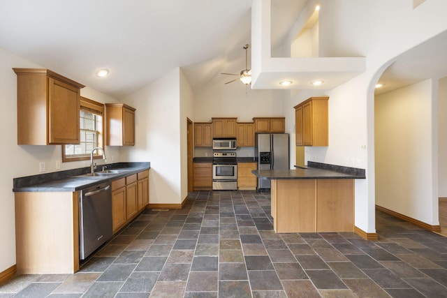 kitchen featuring kitchen peninsula, appliances with stainless steel finishes, ceiling fan, sink, and high vaulted ceiling