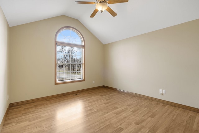 spare room featuring ceiling fan, light hardwood / wood-style floors, and vaulted ceiling