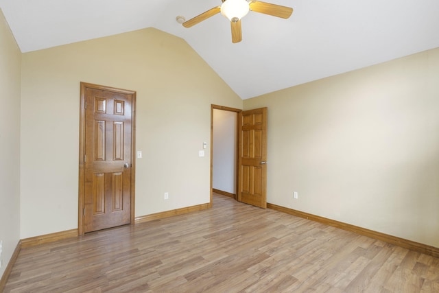 spare room with ceiling fan, light wood-type flooring, and lofted ceiling