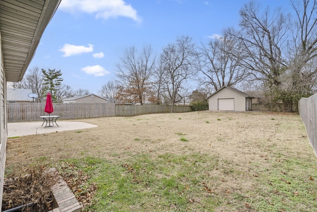 view of yard with an outdoor structure, a garage, and a patio area