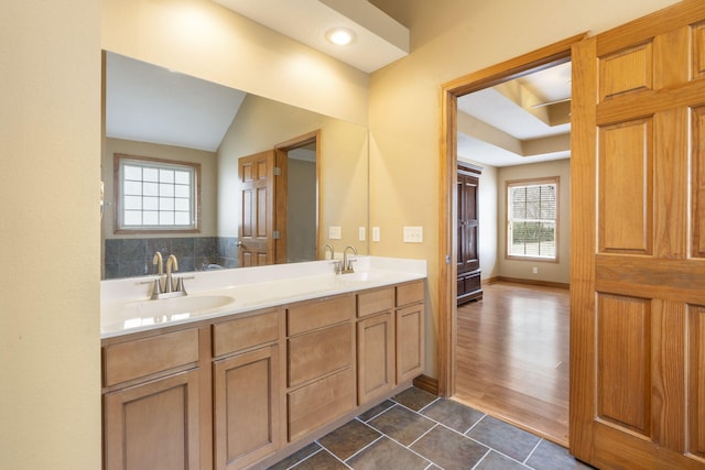 bathroom with tile patterned flooring, vanity, and a wealth of natural light