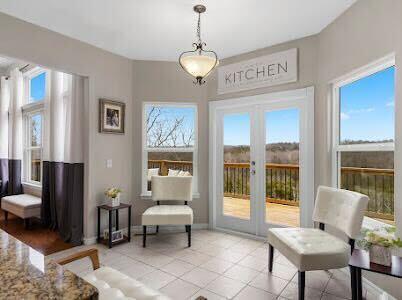 living area with light tile patterned flooring and french doors