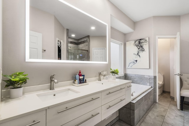 full bathroom featuring tile patterned floors, vanity, shower with separate bathtub, and toilet