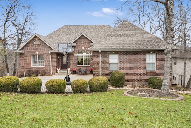 view of front of property with a front yard and a patio