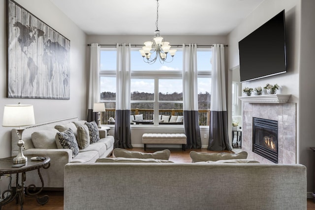 living room featuring a notable chandelier and a high end fireplace