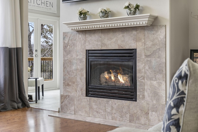 room details featuring a tile fireplace and hardwood / wood-style floors